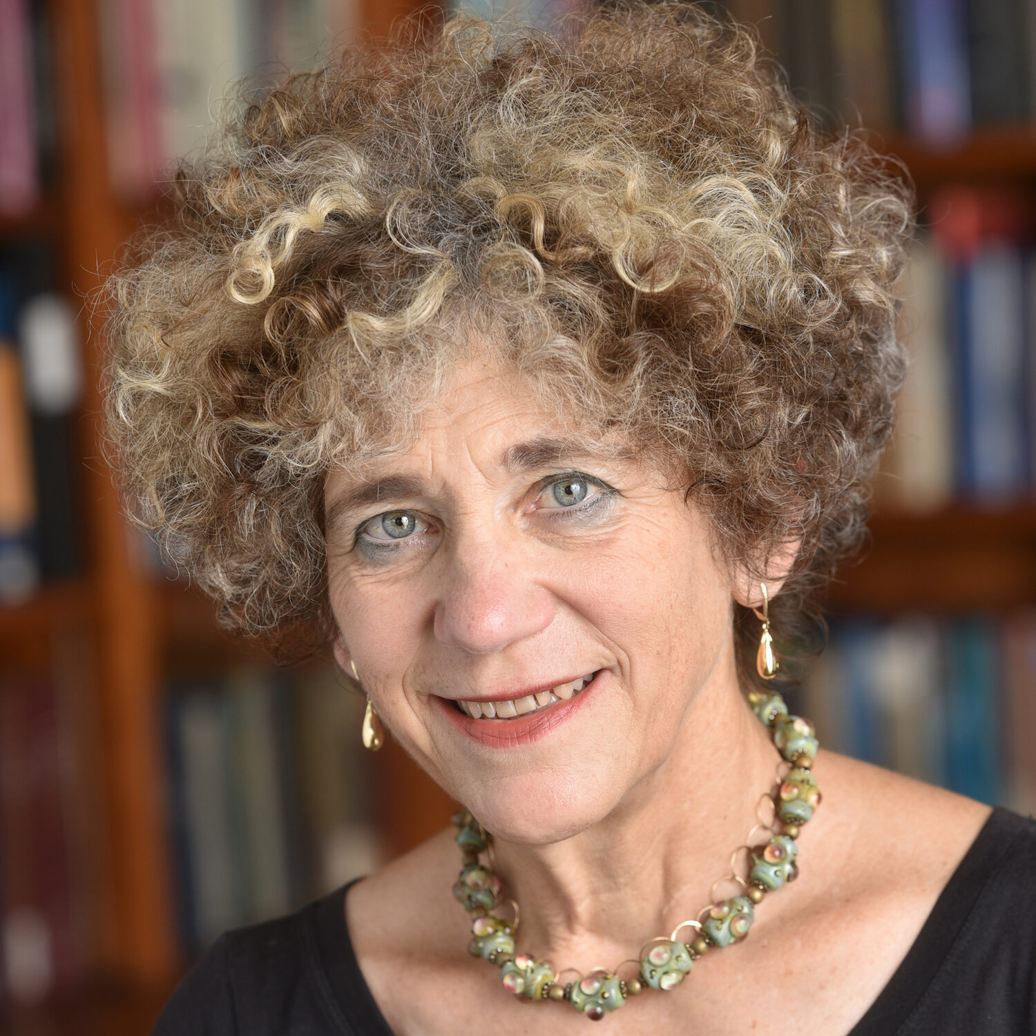 johanna drucker contributor photo, indoors in front of bookshelf