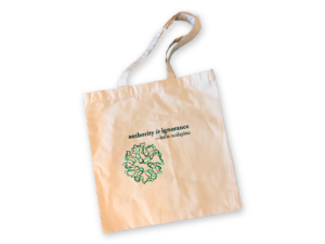 white Leslie Scalapino Tote with Litmus logo and Scalapino quote, "authority is ignorance"
