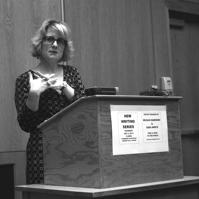 jennifer moxley contributor photo, b&w, speaking at a podium