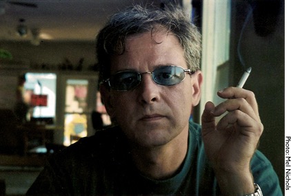 Rod Smith contributor photo, indoors and smoking a cigarette