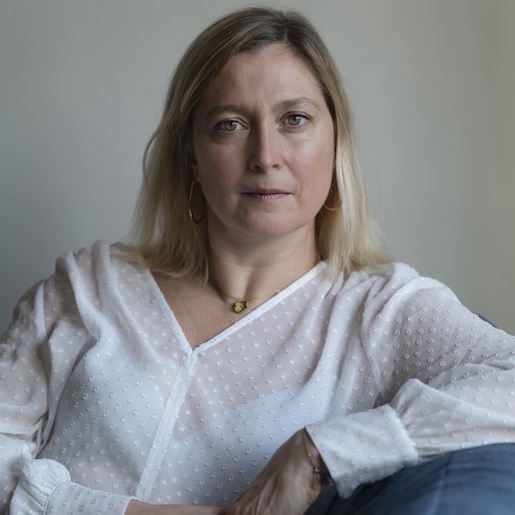 virginie poitrasson author photo with shoulder length blond hair in a white blouse